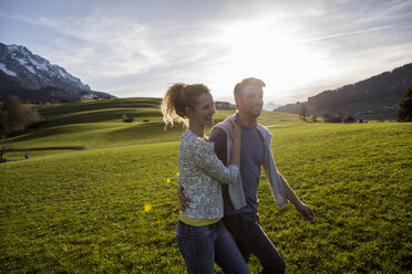 Austria, Tyrol, Walchsee, happy couple hiking on an alpine meadow - JLOF00203