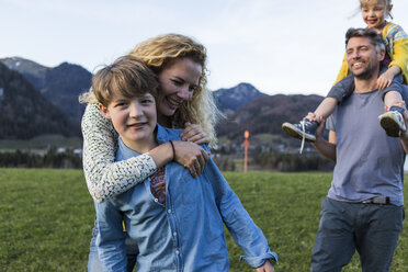 Austria, Tyrol, Walchsee, happy family hiking on an alpine meadow - JLOF00217