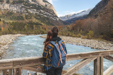 Spanien, Ordesa y Monte Perdido National Park, Rückenansicht einer Frau mit Rucksack auf einer Holzbrücke - AFVF01290