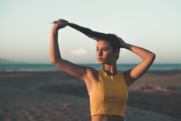 Portrait of teenage girl on the beach at sunset - ACPF00181