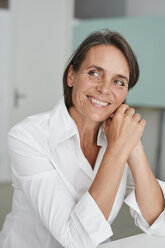 Portrait of smiling mature businesswoman wearing white blouse - PNEF00854