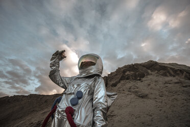 Spaceman on a nameless planet, taking rock samples - VPIF00489