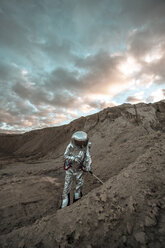 Spaceman on a nameless planet, probing soil - VPIF00498