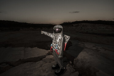 Spaceman pointing at distance at night on a nameless planet - VPIF00503