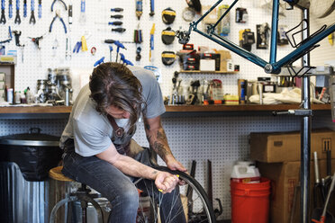 A man working in a bicycle repair shop. - MINF06296