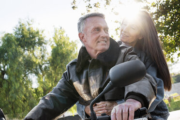 Älteres Ehepaar bei einer Fahrt auf einem Motorrad. - MINF06446