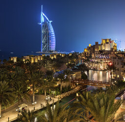 View of illuminated Burj Al Arab skyscraper in Dubai, United Arab Emirates at dusk. - MINF06515