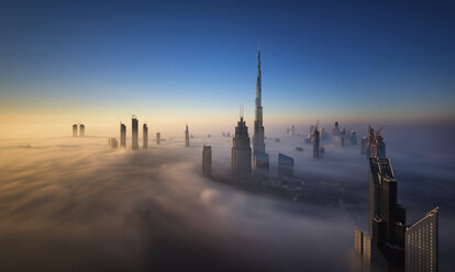 View of the Burj Khalifa and other skyscrapers above the clouds in Dubai, United Arab Emirates. - MINF06517