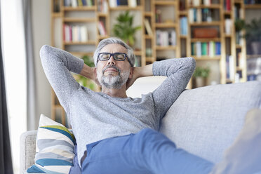 Portrait of mature relaxing on couch at home - RBF06492