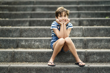 Portrait of relaxed little girl sitting on stairs - JSMF00416