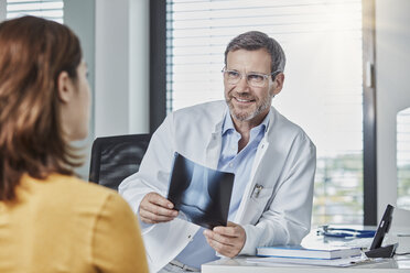 Arzt-Patienten-Gespräch, Arzt hält Röntgenbild - RORF01458