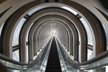 Interior view of contemporary building with escalator running across glass atrium with arched ceiling. - MINF06589