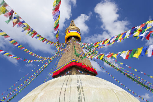 Niedriger Blickwinkel auf bunte Gebetsfahnen auf dem Stupa eines buddhistischen Tempels. - MINF06596