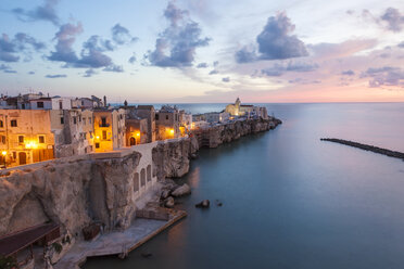 High angle view of traditional houses build on a cliff on the Mediterranean Sea at sunset. - MINF06597