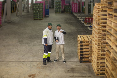 Workers having a conversation in factory - ZEF15958