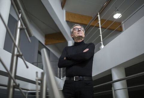 Confident senior businessman standing in office hallway - AWF00191