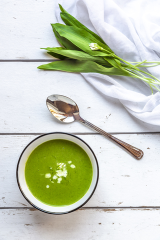 Bowl of ramson soup garnished with cream stock photo