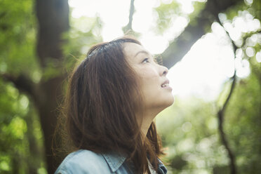 A young woman in woodland, outdoors. - MINF06860