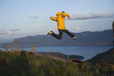 Young adult jumping over lake in Idaho. - AURF00099