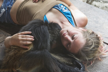 Woman cuddles with monkey in Mexico. - AURF00117