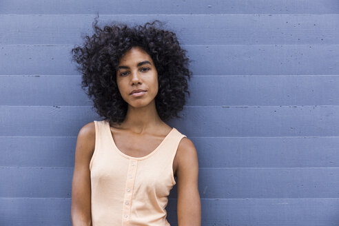 Portrait of young woman with curly black hair - TCF05632