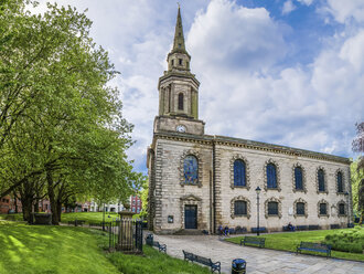 Exterior view of St Paul's Church and tombstones in the churchyard under a cloudy sky. - MINF07462