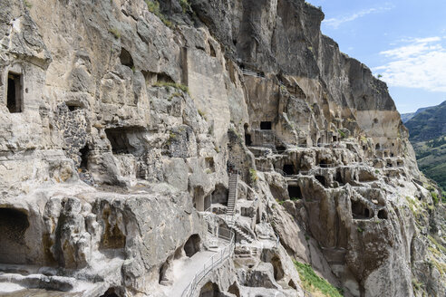 Cave monastery in Vardzia, southern Georgia, with stairways, windows and entrances in the rock face. - MINF07505