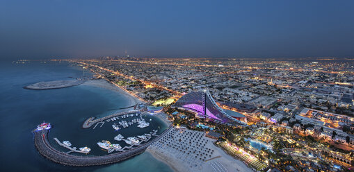 Cityscape of Dubai, United Arab Emirates at dusk, with coastline of Persian Gulf and marina in the foreground. - MINF07534