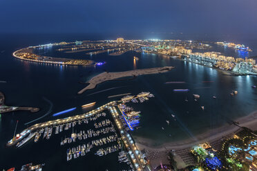 Cityscape of Dubai, United Arab Emirates at night, with coastline of Persian Gulf and marina in the foreground. - MINF07552