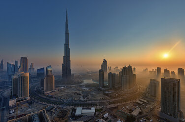 Cityscape of Dubai, United Arab Emirates at dusk, with the Burj Khalifa skyscraper and other buildings in the foreground. - MINF07566