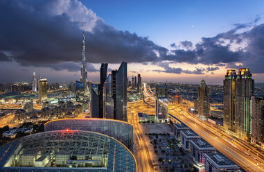 Cityscape with illuminated skyscrapers, Dubai, United Arab Emirates at dusk. - MINF07568