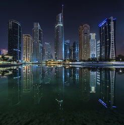 Stadtbild von Dubai, Vereinigte Arabische Emirate, bei Nacht, mit beleuchteten Wolkenkratzern entlang der Uferpromenade. - MINF07582