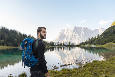 Austria, Tyrol, Hiker with backpack, hiking at Lake Seebensee - DIGF04793