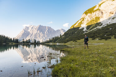 Austria, Tyrol, Hiker with backpack, hiking at Lake Seebensee - DIGF04794
