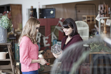 Two Caucasian women shopping in an antique store - MINF07882