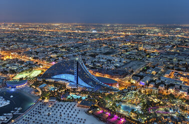 Aerial view of the cityscape of Dubai, United Arab Emirates at dusk, with the Jumeirah Beach Hotel and the marina in the foreground. - MINF08045