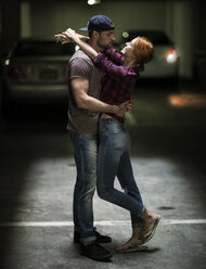 A couple dancing in an underground parking lot. - MINF08082