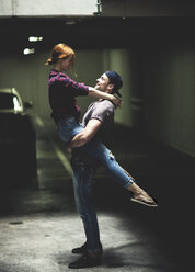 A couple dancing in an underground parking lot. - MINF08084