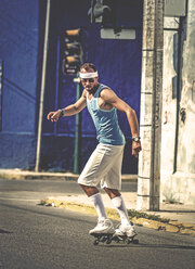 A man rollerskating in a street. - MINF08175