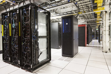 Racks of servers aligned in rows in a large computer server farm. - MINF08318