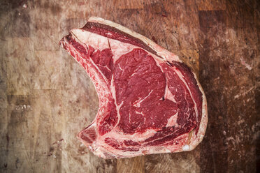 High angle close up of a beef forerib on a wooden butcher's block. - MINF08431