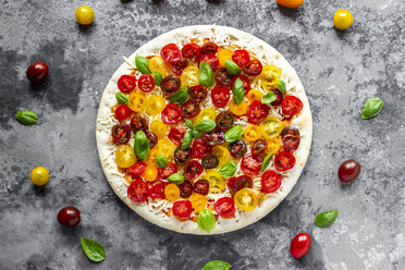 Unbaked pizza with tomatoes and basil leaves - SARF03897