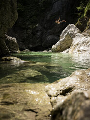 Man jumping from rock into brook - CVF01064