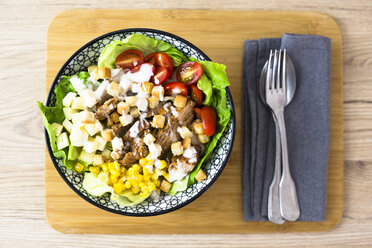 Bowl of Caesar salad with meat, corn and tomatoes - GIOF04128