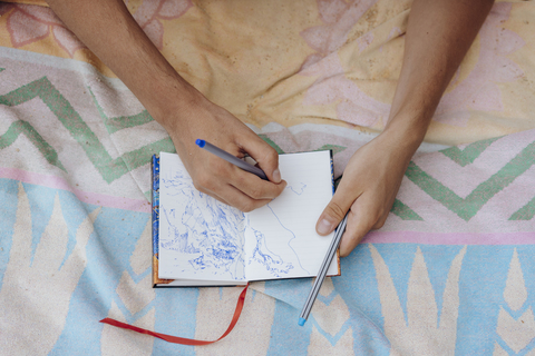 Man drawing in notebook stock photo