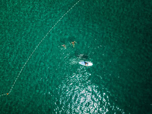 Croatia, Cres, Adriatic Sea, Aerial view of stand up paddle surfing and swimmers - DAWF00704