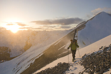 A man backcountry skiing at sunset at high elevation, San Juan National Forest, Silverton, Colorado. - AURF00204