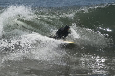 A man in a wetsuit surfing at Punta de Lobos, Pichilemu, Chile. - AURF00219