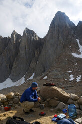 A man boils some water at camp below Mount Whitney in the Eastern Sierra, CA. - AURF00250