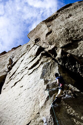 A rock climber makes his way through a difficult section of a climb. - AURF00307